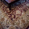 DR02. Wool rug with wine-colored ground. Measures approx. 13'6" x 9'5" 